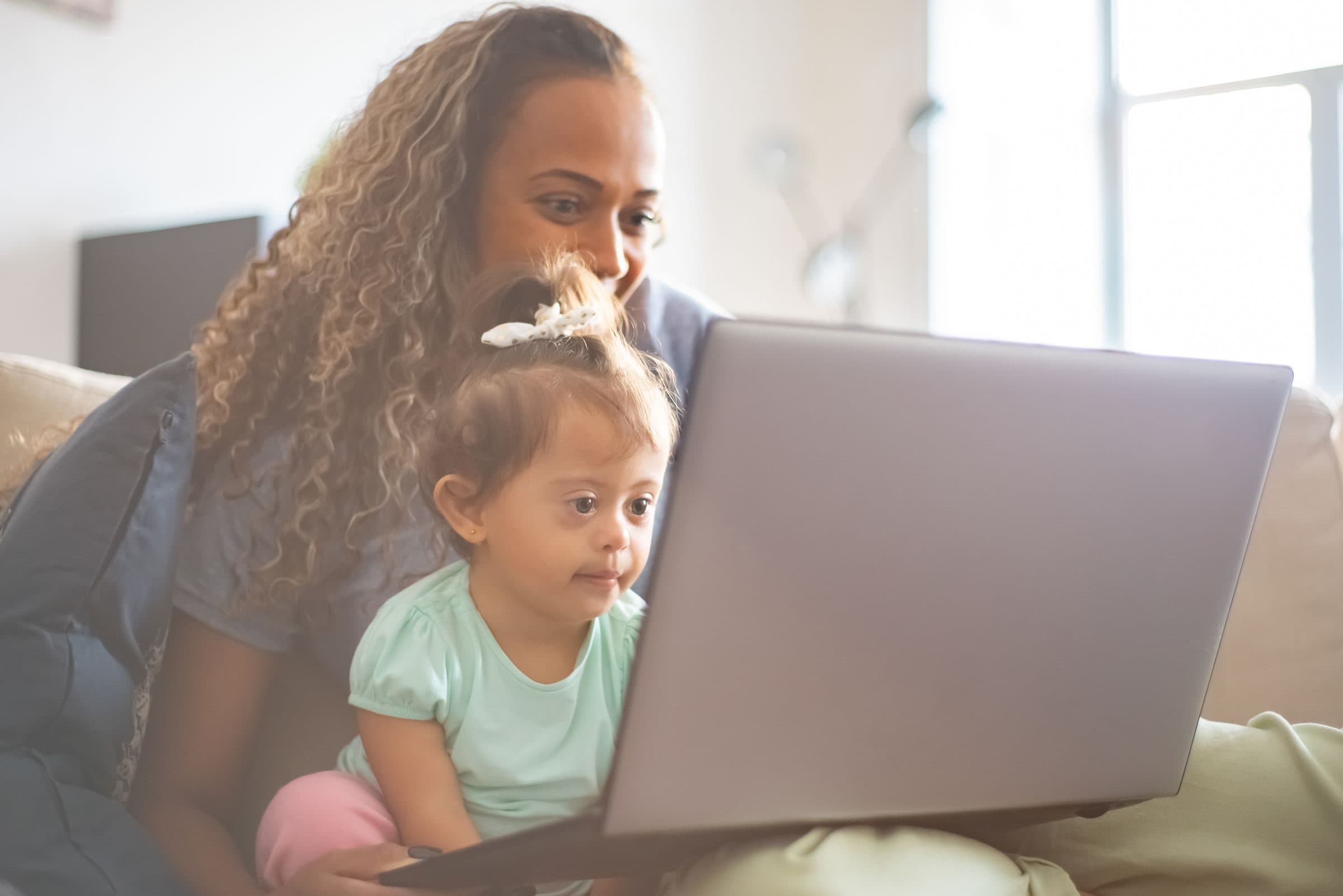 A mother and daughter using a laptop together